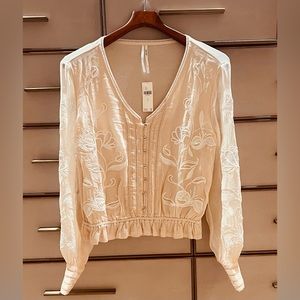 NWT Anthropologie embroidered blouse with ruffle hem. Size small.